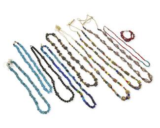 350
A large group of trade beads including Southwest-style beads
Late 19th century to contemporary
Comprising three strands of various multicolored glass, millefiori and other style including African beads, each on a raffia cord, as well as three strands of blue glass and ceramic beads in various shades, including turquoise blue padre beads, a strand of dark blue/black beads with larger black and white spotted beads, a strand of brown and black striped ceramic beads and disks, and a small necklace with small turquoise and red and white glass "white heart" beads of various sizes, and a four-strand bracelet with red, blue, and multicolored beads, 10 pieces
Largest: 32" L; smallest: 21" L; bracelet: 7" L
661.5 grams gross
Estimate: $50 - $75