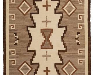 210
Navajo Regional/Two Grey Hills rug
Mid-20th century, Diné
Woven in dark brown, light brown, cream, and natural grey, depicting crosses within an elaborate stepped diamond motif
76" H x 48.25" W
Estimate: $500 - $700
