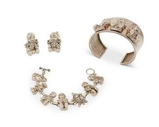 316
A group of Carol Felley sterling silver storyteller jewelry
Late 20th century
Each variously marked for Carol Felly; further variously marked: 88 / 89 / Sterling
Comprising a cuff bracelet with three applied silver seated female storytellers with laps full of children, as well as a silver link bracelet with various storyteller figures and a tortoise, and a pair of earrings, 4 pieces
Cuff: 7 " total inner C x 1.5" H, with a 1.125" gap; link: 7" L x 0.875" H; earrings: 1.25" H
140.9 grams
Estimate: $500 - $700