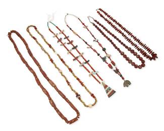 313
A group of Southwest-style carved stone and bead necklaces
Mid/late 20th century
Six single strand necklaces including a strand of chunky large red jasper beads of various shapes, a necklace of yellow glass, coral and red stone beads with ceramic bead accents, a coral and carved multi-stone fetish animal necklace with a chunky stone inlay triangular pendant, a red glass "white heart" bead, shell, and carved stone fetish animal necklace with silver cone clasp, a single strand of large round brown multicolored glass beads, and a strand of graduated amber beads with silver bead spacers, 6 pieces
Largest: 34" L; smallest: 25" L
548.4 grams gross
Estimate: $100 - $200
