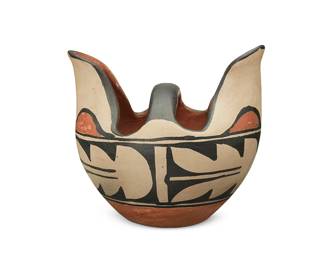 258
A Santa Domingo Pueblo pottery basket
Mid-20th century
The three-color basket with opposed spouts centering a lug handle, featuring orange and black geometric motifs on white slip
6.625" H x 7.375" W x 5.75" D
Estimate: $200 - $400