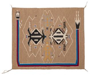 207
A Navajo Yei pictorial textile
Mid/late 20th century, Diné
Woven in blue, red, ochre, black, cream, and light brown wool, depicting four figural elements centering a rainbow guardian
33" H x 39" W
Estimate: $500 - $700