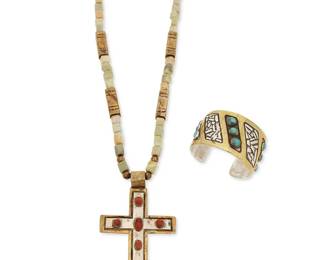 296
Two Southwest style mixed metal jewelry pieces
Late 20th century
Two works:

Wayne Aguilar (b. 1966, Kewa)
A Santo Domingo Pueblo mixed metal cross necklace
Pendant and clasps stamped with artist's cipher
A stamped brass and stone bead necklace with a set coral mixed metal cross pendant
26" L x 4.5" H

A John West mixed metal cuff bracelet with set turquoise
Circa 1976
Etched: John West #345 - '76
With alternating silver and row-set turquoise panels outlined with brass metal overlay
6.75 " total inner C x 1.625" H, with a 1" gap

2 pieces
199.6 grams gross
Estimate: $300 - $500