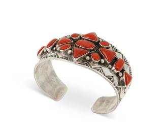 218
A Gary Reeves Navajo sterling silver and coral cuff bracelet
Gary Reeves (1962-2014, Diné)
Late 20th/21st century
A tapered cuff with stampwork edging and oval and triangular set coral cabochons
6.5" total inner C x 1.375" H, with a 1" gap
73.6 grams gross
Estimate: $500 - $700