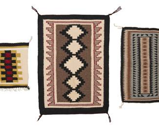 212
A group of Navajo regional textiles
Mid/late 20th century, Diné
Each woven in multicolor wool, comprising a Ganado-style rug depicting stacked stepped diamonds, a smaller textile with elaborate geometric motifs, and a small mat depicting central checkered motif with fringe to one edge
3 pieces
Largest: 26.25" H x 19.75" W; Smallest: 12" H x 11.5" W
Estimate: $200 - $400