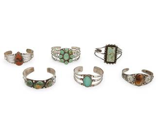 249
A group of Fred Harvey-style Southwest silver cuff bracelets
Mid-20th century
Two marked for sterling; one marked for Bell Trading Post; one marked for Gallup Co. with thunderbird
Six ornate silver and set stone cuffs, including turquoise and jasper, in various styles and sizes, with designs including stampwork, thunderbirds, storm clouds, feathers, and arrows, 6 pieces
Largest: 6.375" inner C x 1.375" H, with a 1" gap; smallest: 6.125" inner C x 1" H, with a 1" gap
161.8 grams gross
Estimate: $300 - $500
