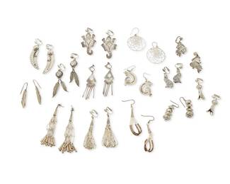 346
An assortment of Southwest-style silver earrings
Late 20th century
Variously marked for sterling and for maker: J. Woolsey / WW / NB
Fourteen pairs of silver earrings in various styles including liquid silver strands, heishi, squash blossoms, feathers, dangles, and pictorial motifs including lizards, wolves (WW), horses, and spider dreamcatchers, 28 pieces
Largest: 3" H; smallest: 1.75" H
110.8 grams gross
Estimate: $100 - $200