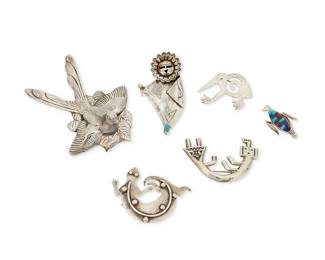 322
A group of Southwest-style silver brooches
Late 20th century
Variously marked for maker and for sterling
Comprising a Francis Jones (b. 1943, Diné) Navajo sterling silver Rainbow Guardian brooch, a PL silver lizard brooch, a signed Zuni-style Sunface dancer sterling silver pendant brooch with set turquoise, a signed diminutive sterling silver corn husk brooch with lapis, turquoise and coral cobblestone inlay, a large Balciar silver metal bird brooch, and an RW hammered sterling silver bird brooch, 6 pieces
Largest: 3.75" H x 2.75" W; smallest: 1.5" H x 0,75" H
99.4 grams gross
Estimate: $200 - $400