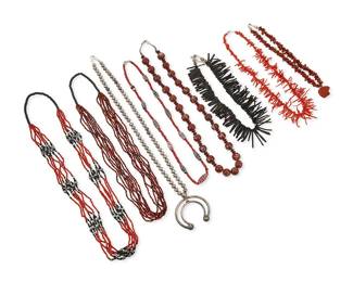 334
A group of Southwest silver, black, and red jewelry
Mid/late 20th century
Unmarked
Eight works comprising a silver bead squash blossom necklace with a two wire naja, a chunky red stone nugget collar necklace with carved stone bear fetish pendant, and two fine coral and black bead multi-strand necklaces, one with silver and hematite-style bead spacers, as well as two single strand branch coral collar necklaces, one black and one red, and two glass bead necklaces, one with large round brown multicolored beads, and one single strand with red and white "white heart" beads and large multicolored glass millefiori accent beads, 8 pieces
Largest: 28" L; smallest: 16.5" L x 1" H
484.5 grams gross
Estimate: $500 - $700