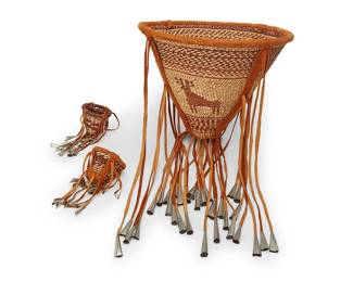 227
Three Apache burden baskets
Late 20th/early 21st century; Southwest United States
The twined basketry vessels, each featuring hide handles and tassel accents mounted with cut metal cones, two with hide woven into rim, comprising one larger depicting deer figures and two diminutive baskets with banded motifs
3 pieces
Larger without tassels: 12" H x 15" Dia.; Each smaller without tassels: 3.25" H x 3.5" Dia.
Estimate: $500 - $700