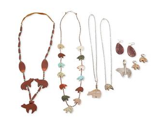 329
A group of Southwest silver and carved stone bear fetish jewelry
Late 20th century
Seven works
Large bear stamped: Nakai / Sterling; bear earrings stamped: B / Sterling
Seven works comprising a chunky carved red stone bear fetish necklace with turquoise and silver bead spacers, a delicate single strand carved multistone bear fetish necklace with shell heishi, a carved stone bear pendant with silver fittings and chain, a pair of similar style carved stone bear and sterling silver earrings, as well as a sterling silver Nakai heartline bear pendant, a small stylized bear pendant with fine chain, and a pair of spiny oyster and turquoise inlay earrings, 9 pieces
Largest necklace: 30" L; smallest: 20" L; pendant: 2.375" H x 2" W; earrings: 2.5" H & 1.25" H
208.7 grams gross
Estimate: $200 - $400
