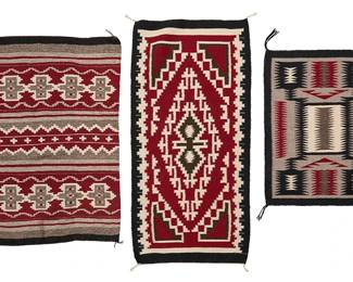 211
A group of Navajo rugs
Mid/late 20th century, Diné
Each woven in red, black, and natural grey wool, comprising one depicting banded, cross, and stepped motifs, a Ganado-style rug depicting central elaborate diamond motif, and a storm pattern rug
3 pieces
Largest: 31.5" H x 24" W; Smallest: 23.25" H x 18.25" W
Estimate: $500 - $700