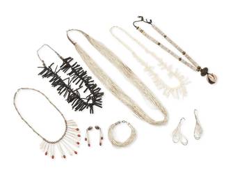 339
A group of Southwest-style silver and shell jewelry
Late 20th century
Eight works comprising a heavy multi-strand liquid silver necklace with sterling silver cone clasp, together with a matching multistrand bracelet and a pair of earrings, as well as a silver and set coral narrow tab necklace with a pair of matching earrings, a graduated white branch coral necklace, a black thin branch coral choker necklace, and a chunky necklace with shell discs, bronze-colored beads, and a wood and shell pendant, 10 pieces
Largest necklace: 32.5" L; smallest: 17.5" L x 2.25" H; bracelet: 7.25" L; earrings: 3.25" H & 2.25" H
409.7 grams gross
Estimate: $400 - $600