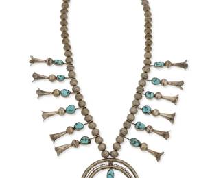132
A Southwest silver and turquoise squash blossom necklace
Early/mid-20th century
Unmarked
Featuring a silver three-wire naja with set turquoise and twelve set turquoise squash blossoms, all suspended from two strands of silver beads
24.5" L x 2.5" H
134.6 grams gross
Estimate: $700 - $900