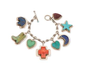 253
A Joan Slifka-style sterling silver and set stone charm bracelet
Late 20th century
Stamped to T-bar clasp: MAM / Sterling
A chunky chain link bracelet with set stone pictorial charms including hearts, moon, bear, boot and star in turquoise, lapis lazuli, spiny oyster, and purple stone, with stamped decorative motifs verso and T-bar clasp
7.5" L x 1.75" H
106.1 grams gross
Estimate: $400 - $600