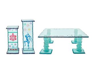 138
A group of David Alan art glass furniture
Circa 1990s
Attributed by artist's pictorial business card
Larger pedestal signed and dated: David A / 01; one table leg signed, not dated
The cut and polychrome glass furniture items comprising a coffee table with stacked glass legs and pigmented kokopeli figure and swirling motifs to top (Top: 40" W x 40" D; Each leg: 14.25" H x 10" W x 10" D), and two pedestals, each with swirling motifs, one depicting a turtle, the other depicting a kokopeli figure (Larger: 30.25" H x 12" W x 12" D; Smaller: 24.25" H x 12" W x 12" D)
7 pieces
Estimate: $500 - $700