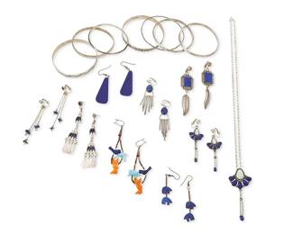 348
A group of Southwest silver and blue stone jewelry
Late 20th century
Variously marked for sterling and for maker: RW [possibly Rosana Williams, Navajo/Diné] / Douglas Etsitty / Denny / DN
Comprising a cluster-set silver, lapis lazuli and opal pendant necklace, with a pair of matching RW earrings, as well as seven further pairs of earrings with lapis lazuli stones in various styles including needlepoint dangles, set stones, teardrop slabs, and tiny nuggets, as well as two pairs with carved stone bear fetish figures and heishi, together with seven silver bangle bracelets, including four marked sterling: two with traditional stamping, and two Douglas Etsitty (b. 20th century, Diné) Navajo bangles with ornate stampwork banding, 24 pieces
Necklace: 22" L x 2.75" H; earrings: 3.25" H to 2.25" H; bangles: 8.75" Dia. to 7.5" Dia.
161.5 grams gross
Estimate: $100 - $200