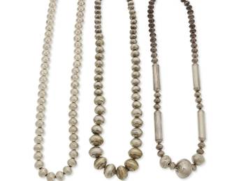 330
Three Navajo silver necklaces
Mid/late 20th century, Diné
Unmarked
Comprising three silver bead necklaces designed with beads of various shapes and sizes, one with decorative stamping to bead tops and one with barrel beads, 3 pieces
Largest: 27" L; smallest: 25.5" L
316.0 grams
Estimate: $200 - $400
