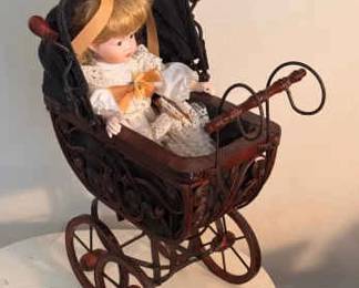 Porcelain MANN Doll In A Wooden Stroller
