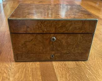 Burlwood box with travel toiletry items fitted interior.