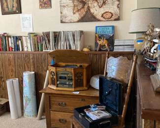 Maps, magazines, books, VHS's, Electro Brand phonograph, cassett, disc player, small chest,