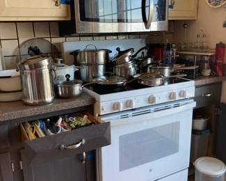 Lots of pots and pans and baking dishes, kitchen utensils