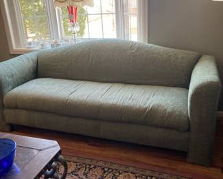 Camel back green sofa