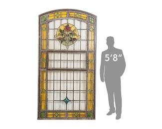 Vintage monumental seven-foot-tall stained glass window from the Spaghetti Warehouse (San Antonio, Texas), leaded, with polychrome glass pieces with rosette motifs