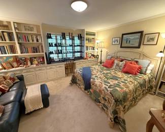 Upstairs bedroom filled with vintage furnishings, Designer shoes, blue leather sofa & books