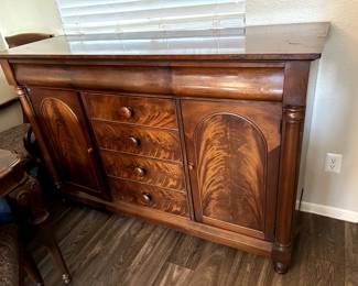 Custom ordered mahogany sideboard.  Two side doors that open for storage dishes.  3 top drawers, with middle drawer equipment for silverware.  Measures 62” long x 42” tall x 22” wide.