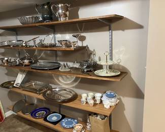 Silver pitchers, platters, serving trays, bowls, gravy boats, ladle, demitasse coffee cups, Wedgewood plates, holiday china tiered platter, candlesticks