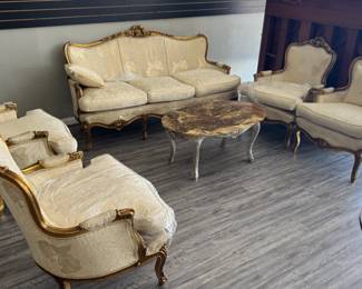 Elegant French-Style Parlor Set with Gilt Frames and Floral Upholstery
This beautiful parlor set will add a touch of classic elegance to your home. The set includes a loveseat, two armchairs, and a matching coffee table, all featuring a distinctive French-inspired design.