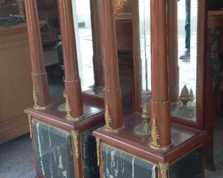 Pair of Elegant French Empire Style Marble Pedestal Stands with Mirrored Supports
This is a stunning pair of French Empire style pedestal stands that will add a touch of classic elegance to any interior. Crafted with rich, dark-stained wood, these stands feature striking green marble bases with dramatic veining, a hallmark of the Empire style.