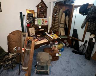 Gun Cabinet; Gun Cases; Tackle Boxes; Fishing Nets; camo Bags; Wooden Anheuser Busch box; Books; Winchester/ Olin Coffee Mugs/ Metal Olin Calendar Frame; Bow; Arrows