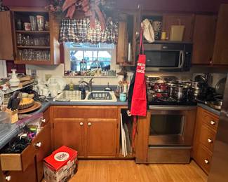 Glasses; Strawberry Shortcake Coffee Mug; Corelle Ware Floral Pink Design; Magic Bullet; Glass Cake Cover; Knives; Knife Block; Wooden Lazy Susan Tray; Wooden Nut Bowl and Crackers; Aprons; Dish Drainer; Kitchen Utensils; Cookware; Soup mugs
