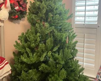 large unlit tree  and lots of other christmas items