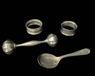 Sterling silver spoon, baby rattle, napkin 
rings 