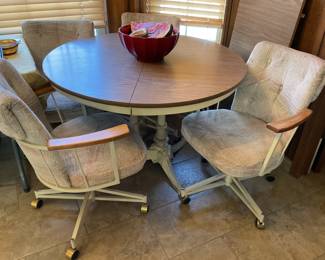 Round table comes with leaf chairs are on wheels