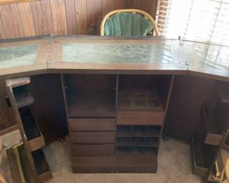 Vintage Mid-Century Wood bar-65x 40x23, features a marble like top, built in bottle and glassware storage, and multiple shelves and drawers