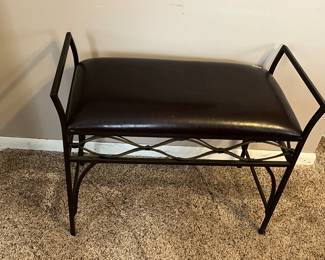 Small brown leather bench with iron legs