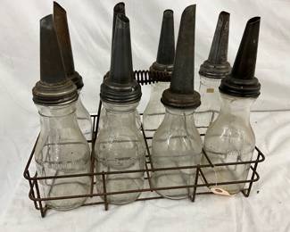 Eight Vintage Glass Bottles with Metal Spouts and Wire Carrier