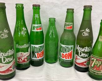 6 MT. DEW BOTTLES & (1) 7-UP BOTTLES