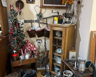 Oak cabinet, leaded glass door with 3 adjustable shelves.  Cast iron pans, meat grinder, 19 red-handled kitchen tools (displayed on Xmas tree), wooden coffee mill, vintage milk crates and more.