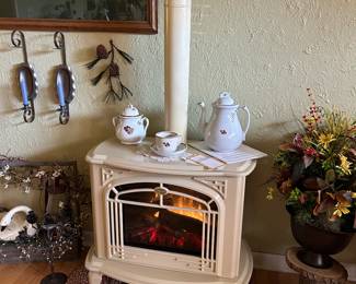 Electric fireplace with fire-like log lighting and heater.  Pipe is removable for more modern look. Excellent condition with instructions.
