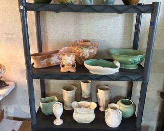 This entire rack is vintage pottery! Roseville, Weller, Hall, and more.