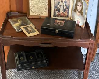 A nice mahogany end table filled with vintage men’s accessories and some religious art