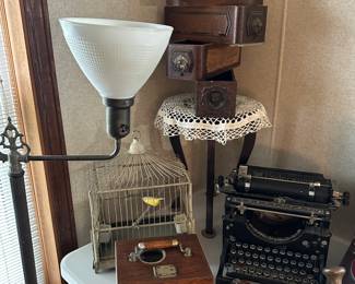 Lots of vintage treasures here! A nice sold brass floor lamp, A great vintage birdcage, small three legged table, and several old Singer Sewing Machine Drawers.