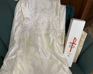 This picture does not do this vintage wedding dress justice. The detail is exquisite.! Also the white box is a wedding candle, unused!