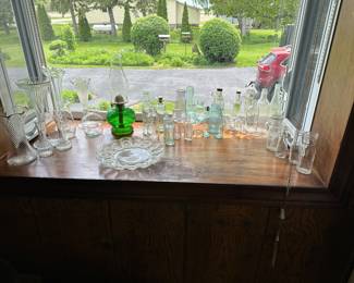 Here’s a lovely display of vintage bottles and glassware! The green stand out in the middle is a lovely old oil lamp!