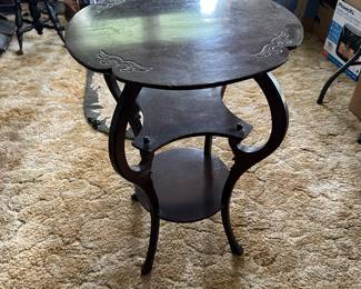 This is a beautiful, three tiered parlor table